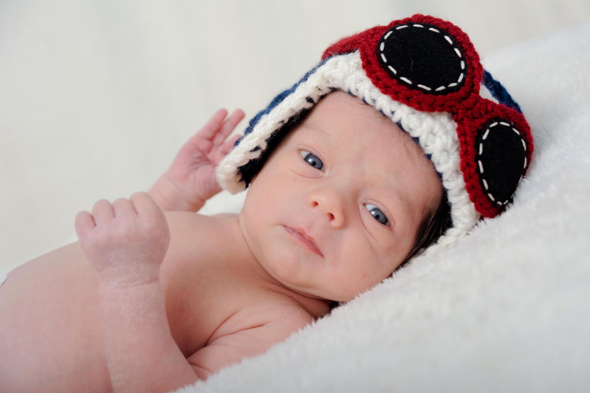 Best Detroit infant photographer takes fun, candid infant portraits like this baby aviator in metro Detroit, Michigan at my Troy, Michigan studio.