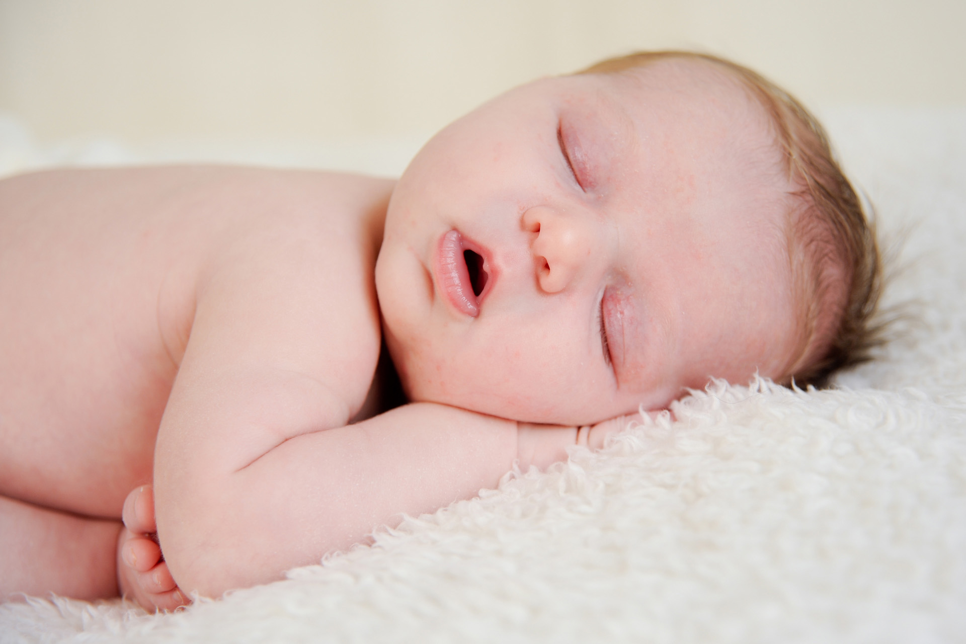 Best Detroit infant photographer rarely gets to photograph sleeping babies like this one who is totally sacked out during her candid baby photo session in metro Detroit, Michigan.
