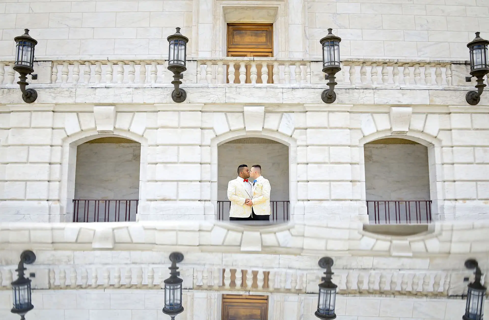 Two grooms pose at the iconic DIA Detroit Institute of Arts building for this epic LGBTQ wedding portrait.