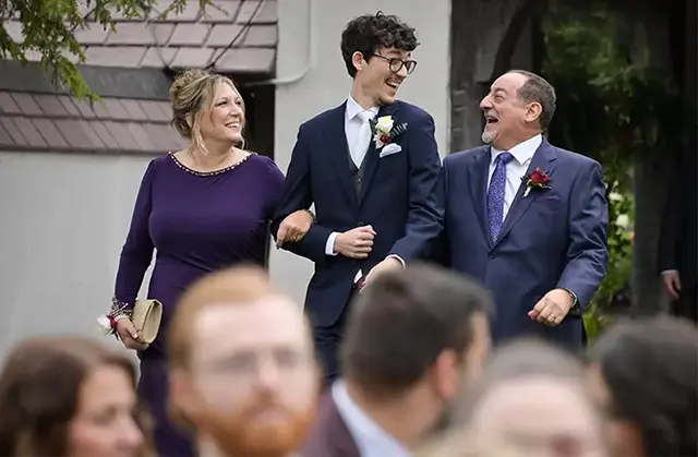 Groom laughing with parents at Addison Oaks Buhl Estate