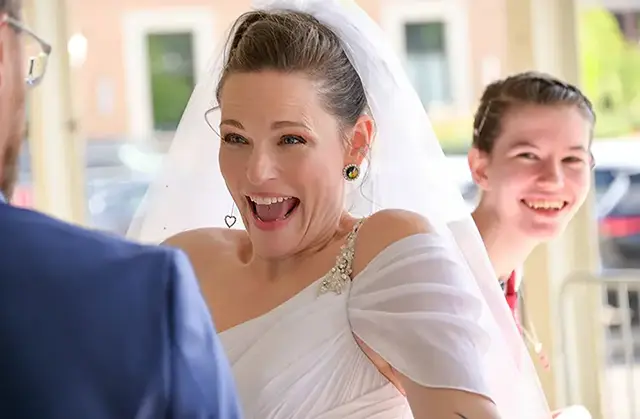 Bride gets ready to hug her new groom after her wedding at the Royal Oak Farmers Market in Metro Detroit, Michigan.