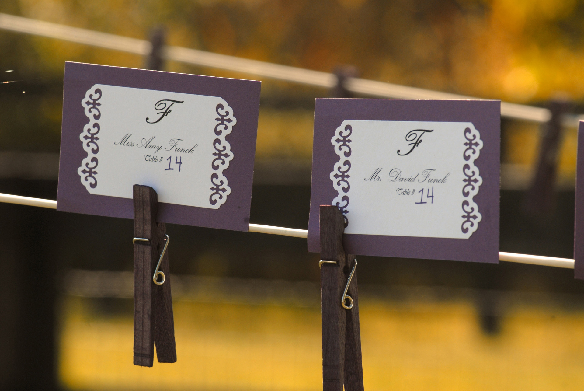 Favorite Michigan backyard wedding photography features photojournalist photos of guests name tags strung on a close line before a wedding in metro Detroit, Michigan featuring their lovely backyard garden wedding in fall.