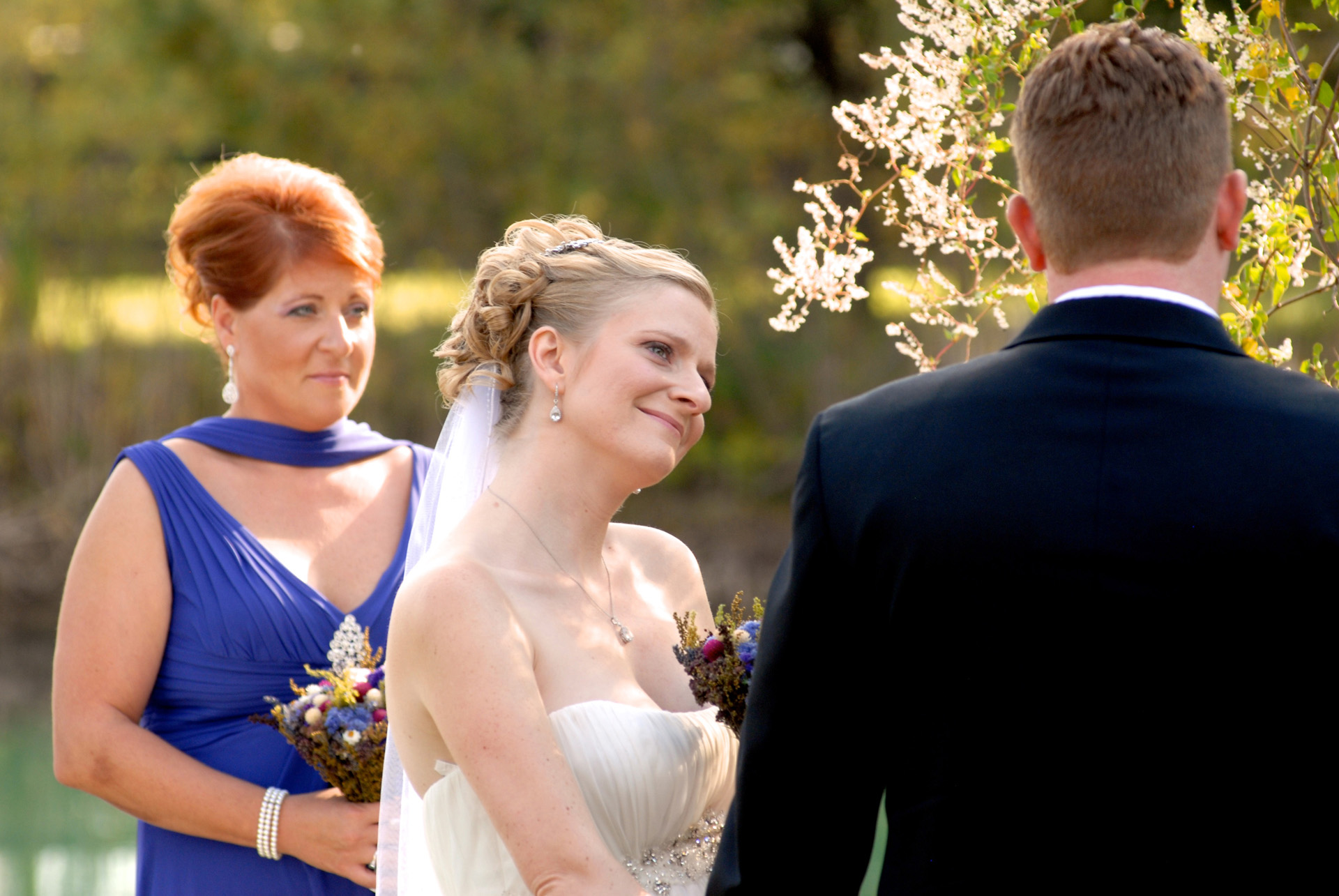 Best Michigan backyard wedding photography features photojournalist photos of  the bride listening to her groom's vows in metro Detroit, Michigan featuring their lovely backyard garden wedding in fall.