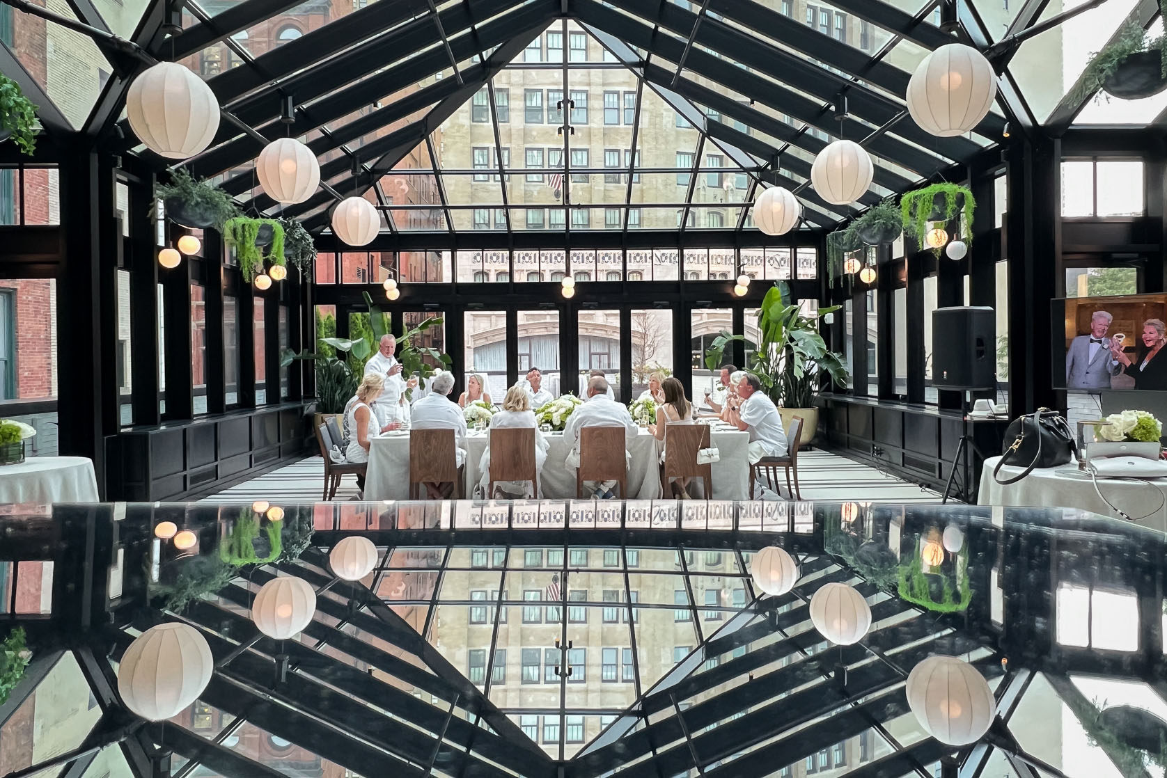 The wedding guests enjoying toasting the couple after revealing their surprise wedding at their intimate wedding reception at the Shinola Hotel in Detroit, Michigan.