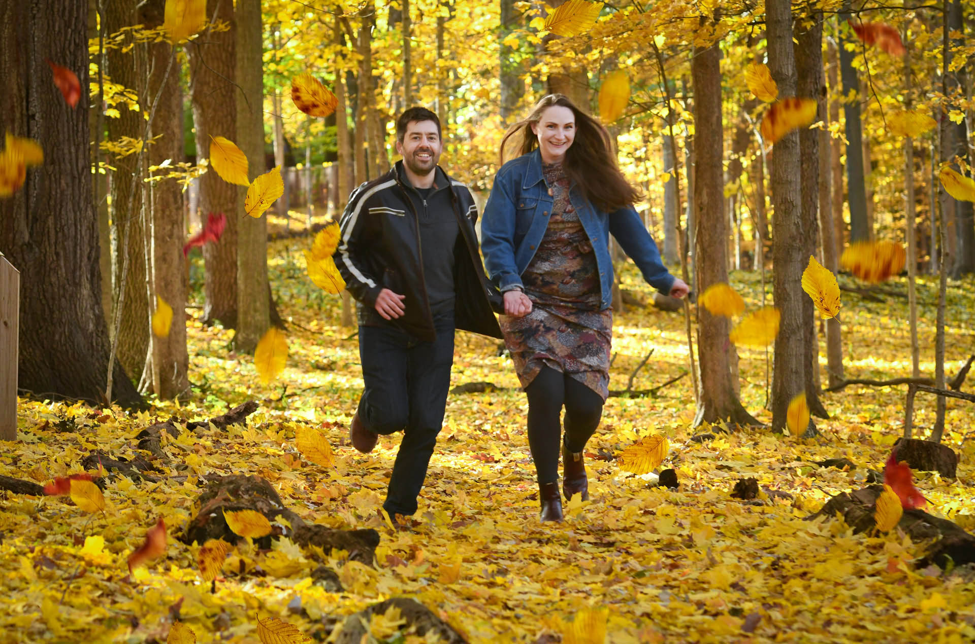 Best Troy lifestyles photographer takes a photo of a engaged couple snuggling on a late fall afternoon at a park in Metro Detroit and Troy, Michigan.